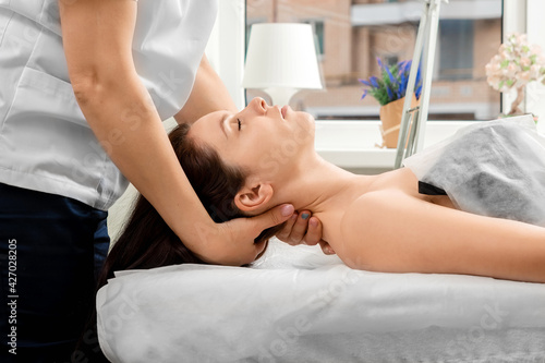 A beautiful girl is doing a neck massage. Skin care, beautician, spa treatments, relaxation.