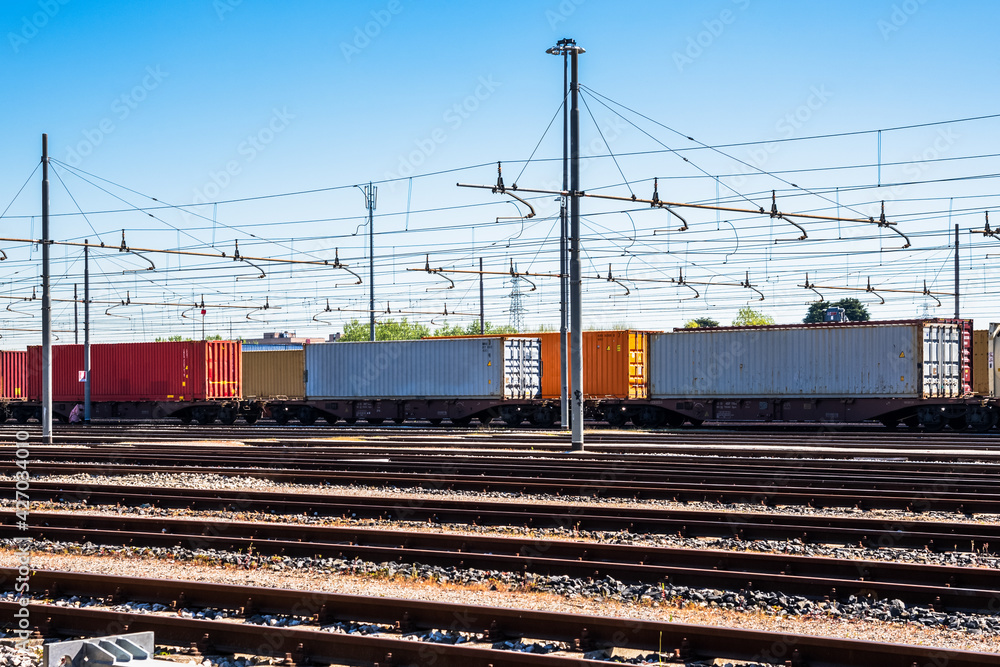 Cargo trains loaded with containers in a freight terminal on a clear spring day