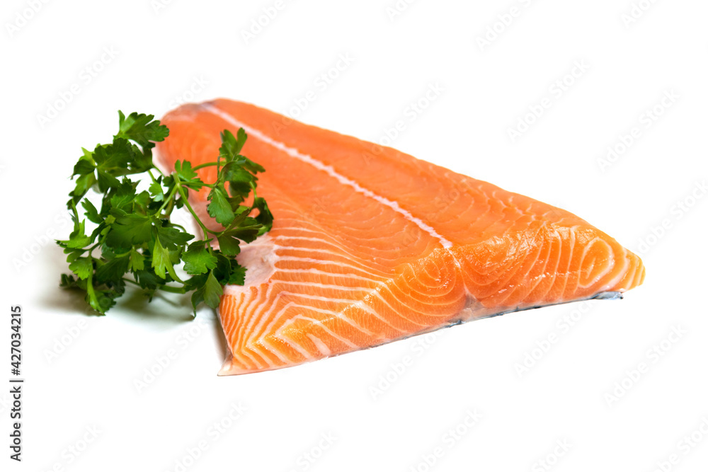 Fillet of salmon meat with parsley isolated on white background. Cut of a fish carcass. Fillet of salmon meat with parsley isolated on white background. Cut of a fish carcass.