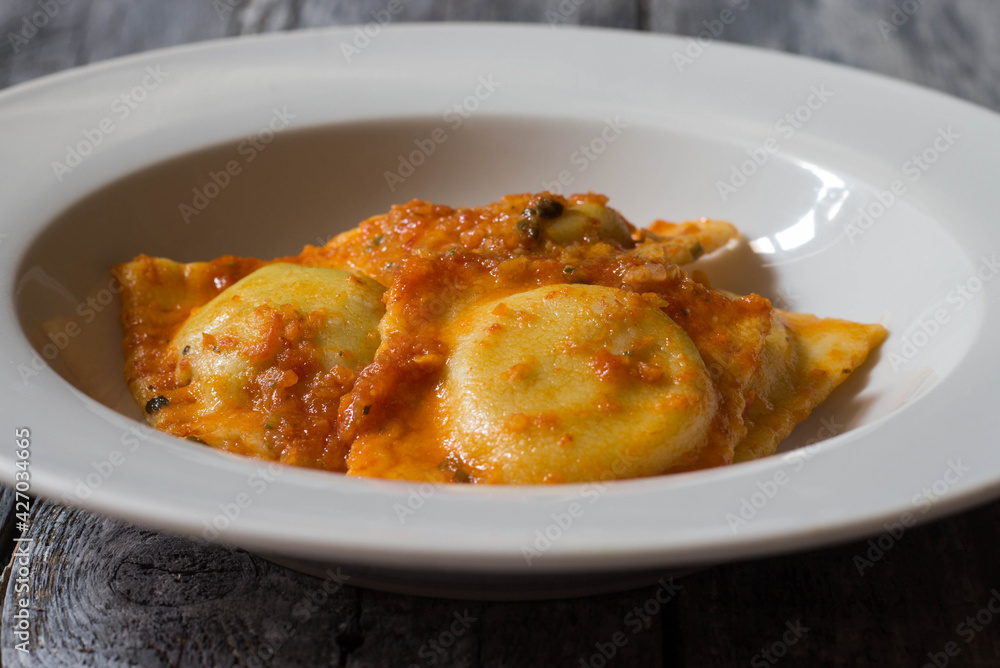 Homemade ravioli stuffed with borage and potatoes dressed with vegetarian ragout Homemade ravioli stuffed with borage and potatoes dressed with vegetarian ragout