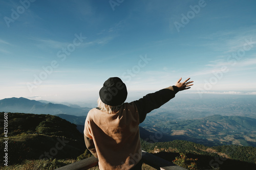 young Japanese cute teen girl brunette women tourist adult woman asian mature looking the sky outdoors on a hike mountains camping taking a photo
at Doi Inthanon National Park, Chiang Mai, Thailand.