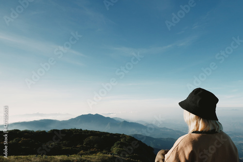 young Japanese cute teen girl brunette women tourist adult woman asian mature looking the sky outdoors on a hike mountains camping taking a photo at Doi Inthanon National Park, Chiang Mai, Thailand. © Tony