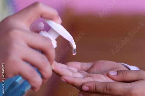 Hand cleaning with alcohol gel, Pressing the alcohol bottle.