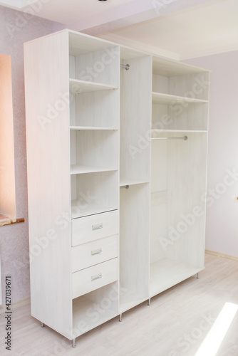 Cabinet furniture, light-colored wardrobe in the room after renovation