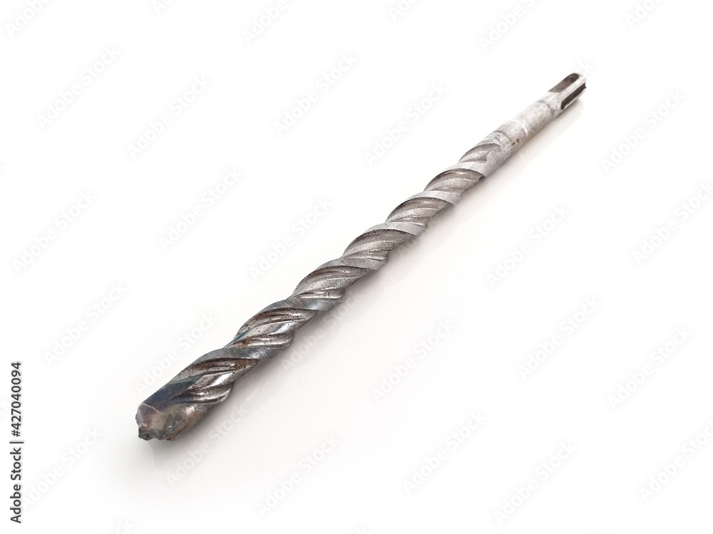 Aerial view of metal drill bit isolated on white background. Close up of Metal tool for making holes. Hardware and Masonry Material pattern. Aerial view of metal drill bit isolated on white background. Close up of Metal tool for making holes. Hardware and Masonry Material pattern.