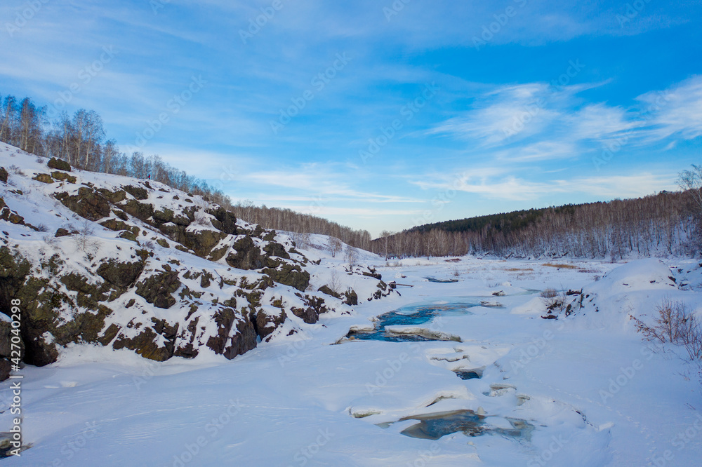 Dawn in the Urals in nature. Landscape with the Ural taiga in winter.