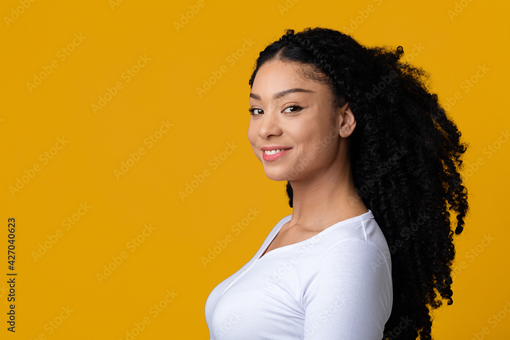 Portrait Of Modern Smiling Indian American Woman Posing Over Yellow Background Portrait Of Modern Smiling Indian American Woman Posing Over Yellow Background