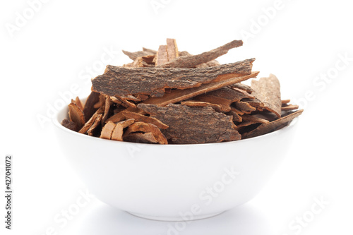 close-up of Organic cinnamon ( Cinnamomum verum) or dalchini on a ceramic white bowl. Pile of Indian Aromatic Spice. photo