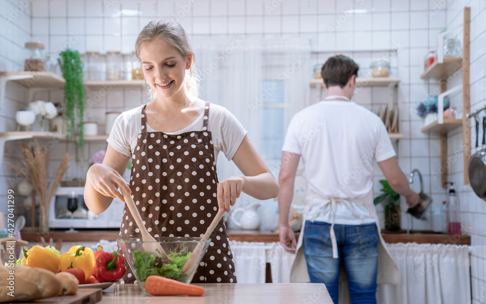 Couples having fun together while cooking in the kitchen, Eating good food for good health. Couples having fun together while cooking in the kitchen, Eating good food for good health.