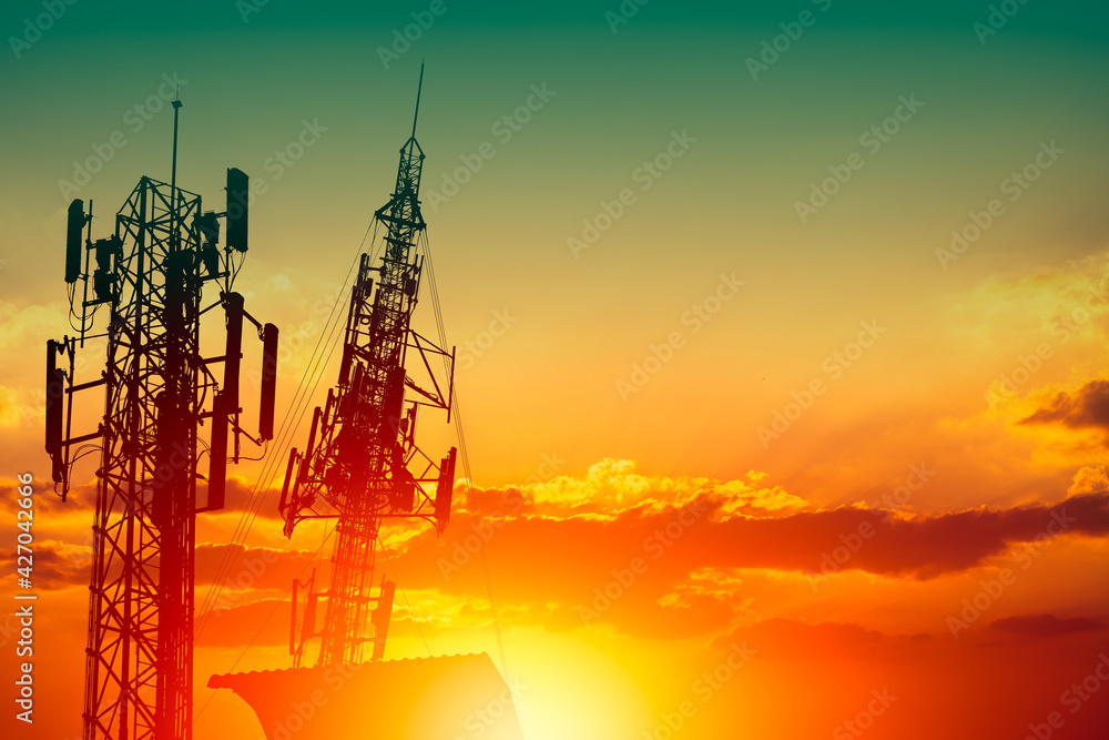 Silhouette of high frequency 5G station communication tower or 4G network telephone cellsite with dusk sunset sky with space for text