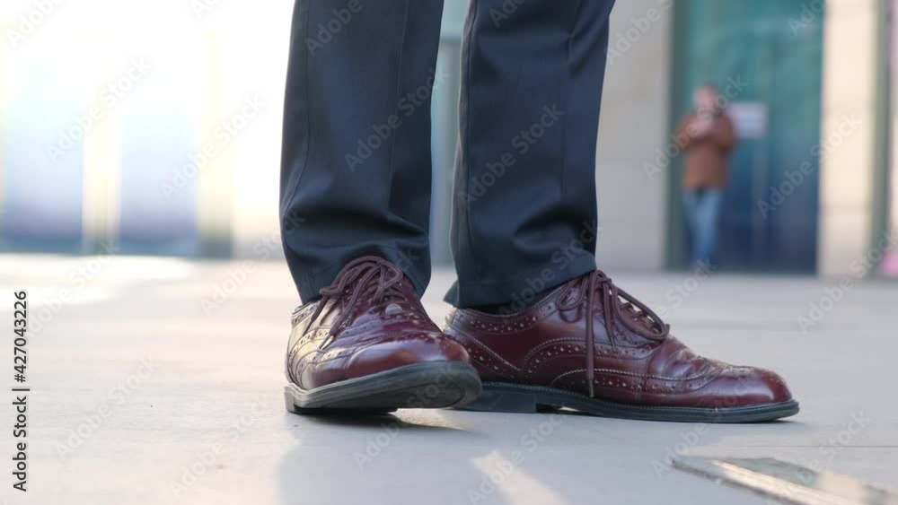 Late and excitement before the meeting concept.Man tapping his shoes while waiting for someone, close-up Late and excitement before the meeting concept.Man tapping his shoes while waiting for someone, close-up
