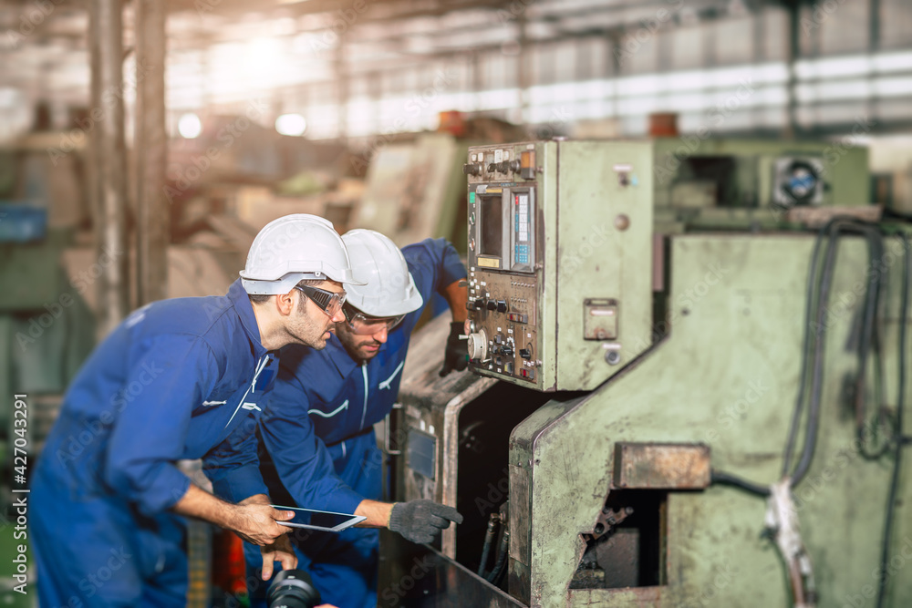 Engineer checking machine maintenance service with team working together teamwork in steel heavy factory Engineer checking machine maintenance service with team working together teamwork in steel heavy factory