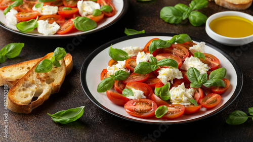 Caprese salad with cherry plum tomatoes, mozzarella cheese and basil. Healthy vegetarian food