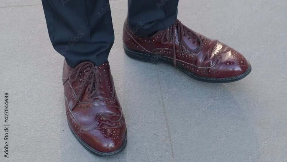 Man tapping his shoes while waiting for someone, close-up Man tapping his shoes while waiting for someone, close-up