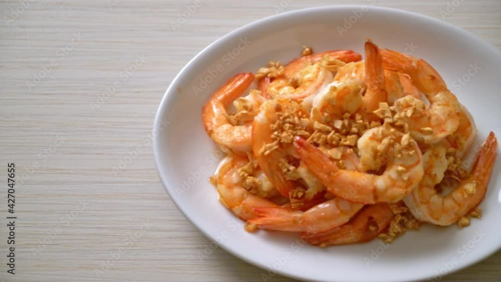 fried shrimps or prawns with garlic on white plate - seafood style fried shrimps or prawns with garlic on white plate - seafood style