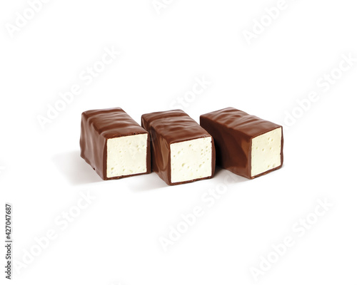 Three chocolate candies bird's milk with soft filling. Delicious glazed sweets filled with whipped milk soufflé. photo