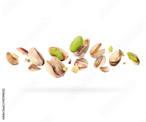 Crushed pistachios close-up hovered in white space photo