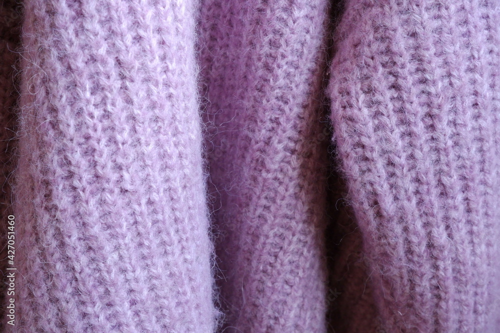 Knitted sweater background. Purple sweater. Cozy sweater. Knitted sweater background. Purple sweater. Cozy sweater.