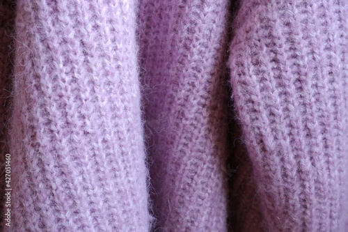 Knitted sweater background. Purple sweater. Cozy sweater. © Volkova Evgeniia