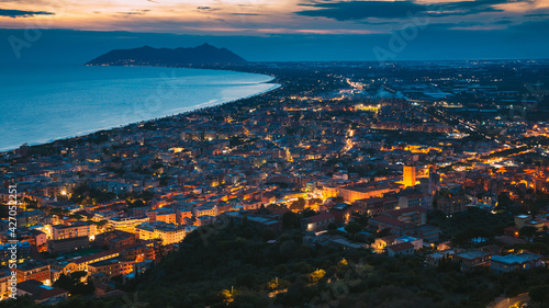 Terracina, Italy. Top View Skyline Cityscape City In Night Illuminations.