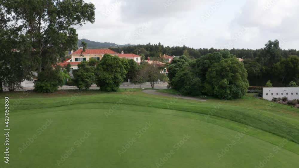 Aerial backwards shot of empty golf course with beautiful green grass. No players during pandemic. Nature Recovery. Aerial backwards shot of empty golf course with beautiful green grass. No players during pandemic. Nature Recovery.