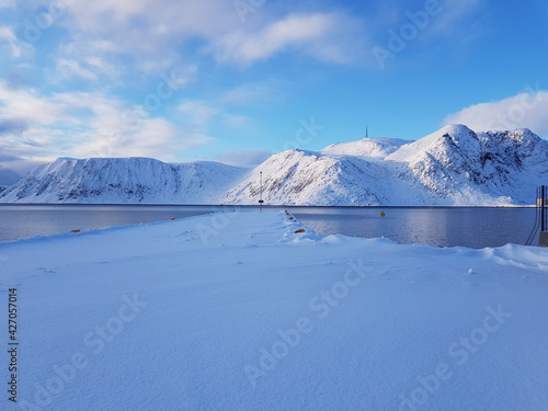 Snowy mountain and blue fjord lanscape in the arctic circle