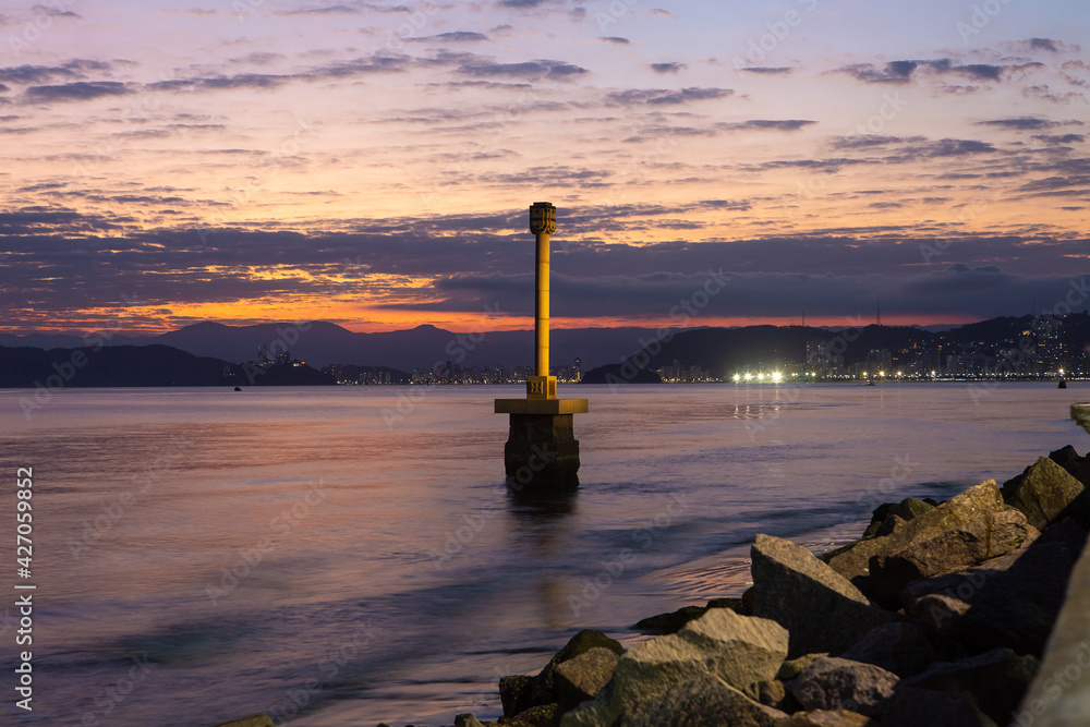 View of the city of Santos during a sunset. In the foreground is the landmark where Martim Afonso de Souza landed in Brazil in 1532