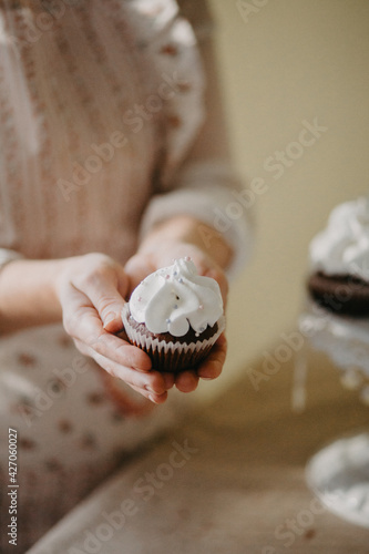 confectioner makes sweet delicious cakes at home. in bright colors