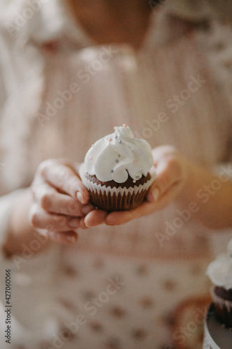 confectioner makes sweet delicious cakes at home. in bright colors