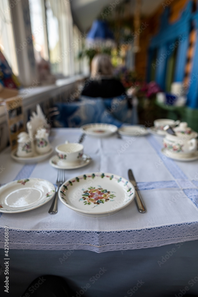 Fototapeta premium still life with food on a white plate on a white table on a sunny veranda 
