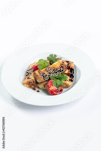 Eggplant and tomato salad with soy sauce and sesame seeds