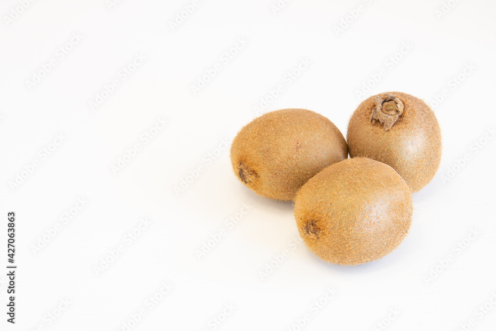 Whole fresh kiwi fruits isolated on white background with copy space for text Whole fresh kiwi fruits isolated on white background with copy space for text