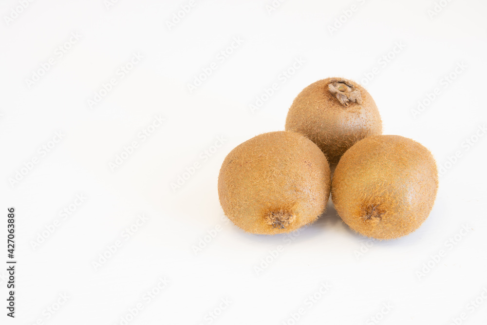 Whole fresh kiwi fruits isolated on white background with copy space for text Whole fresh kiwi fruits isolated on white background with copy space for text