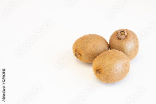 Whole fresh kiwi fruits isolated on white background with copy space for text