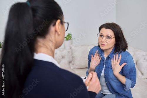 Midlife crisis, mature woman in consultation with psychologist