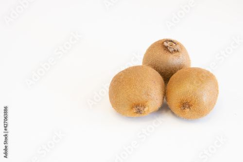 Whole fresh kiwi fruits isolated on white background with copy space for text