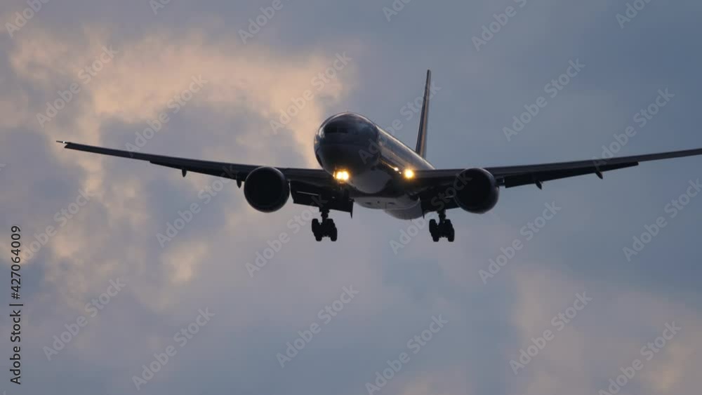 Silhouette of an airplane in the evening sky Silhouette of an airplane in the evening sky