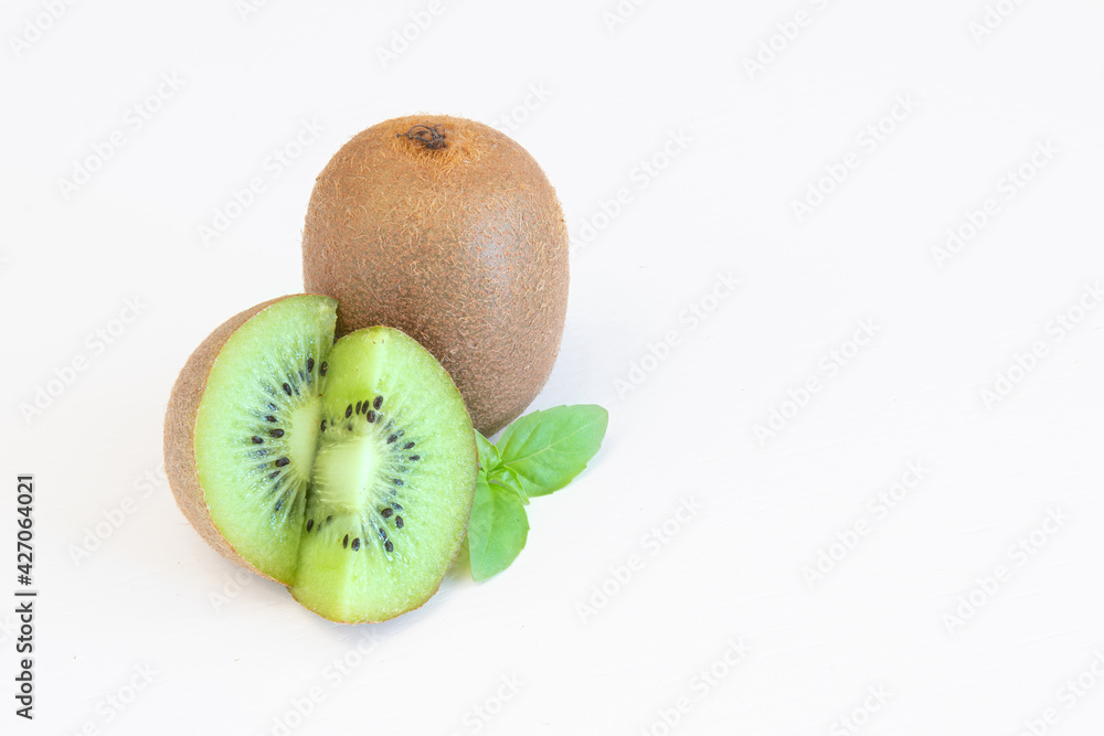 Obraz premium Whole and halves kiwi fruits isolated on white background with text space