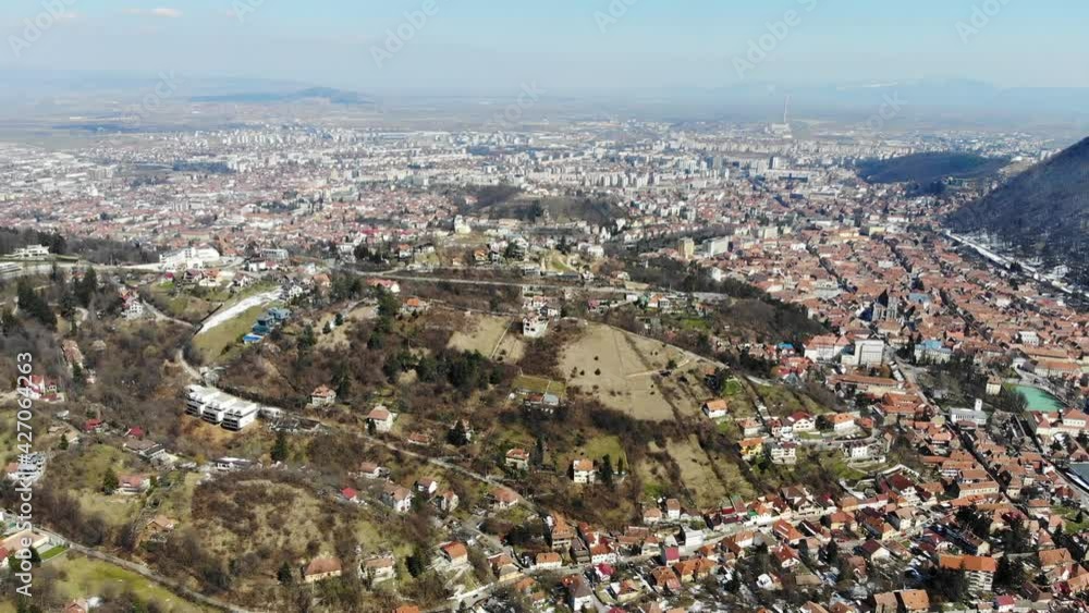 Flying over the hills surrounding the historic city center of Brasov on a sunny winter day Flying over the hills surrounding the historic city center of Brasov on a sunny winter day