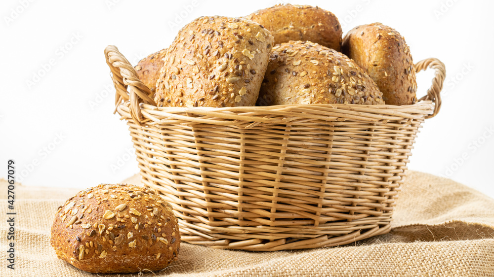 Rye bread. Bakery with crusty loaves and crumbs. Fresh loaf of rustic traditional bread with wheat grain ear or rye spike plant on natural cotton background. Healthy Food concept.