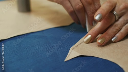 Wallpaper Mural seamstress workplace. Woman seamstress makes pattern with chalk on fabric for sewing clothes in tailor studio. Torontodigital.ca