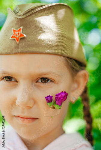 Wallpaper Mural Little caucasian girl portrait with flowers on cheek and military hat Torontodigital.ca