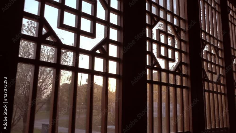 Chinese ancient traditional wooden decorative doors and windows, moving indoors, sunset background Chinese ancient traditional wooden decorative doors and windows, moving indoors, sunset background