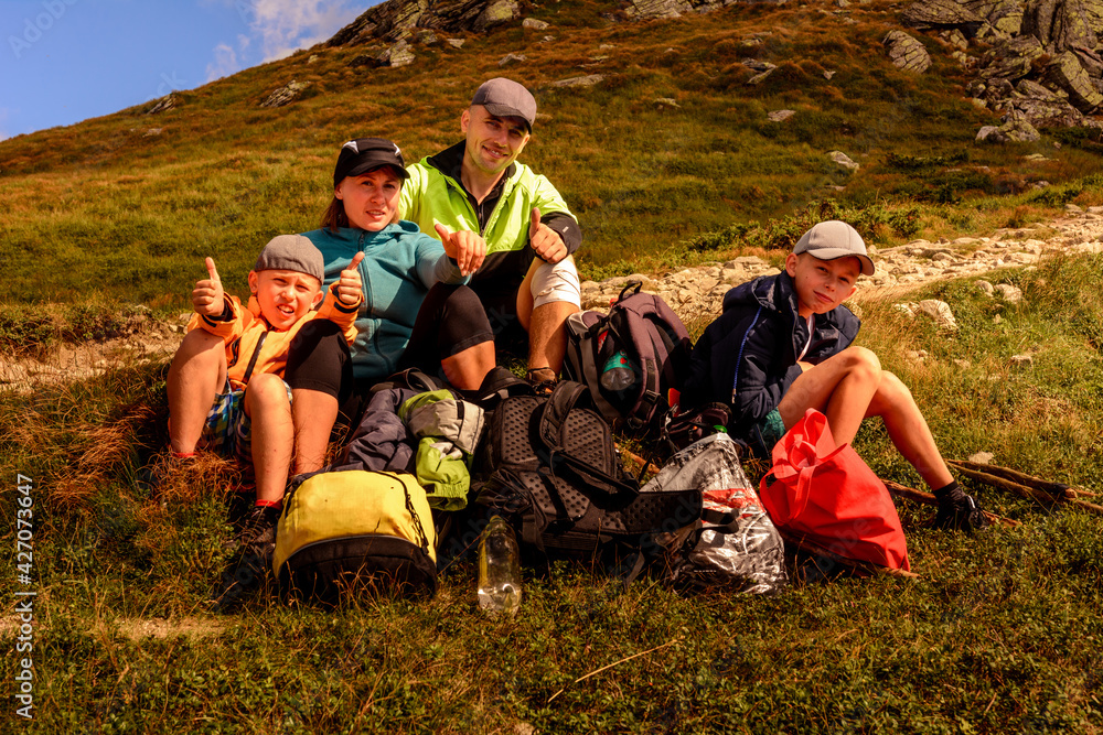 A young family with children travel through the mountains of the Carpathians, rest and gain strength to go further, admiring the scenery. A young family with children travel through the mountains of the Carpathians, rest and gain strength to go further, admiring the scenery.