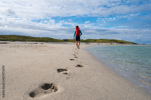 Walking on beach leaving footprints © Chris