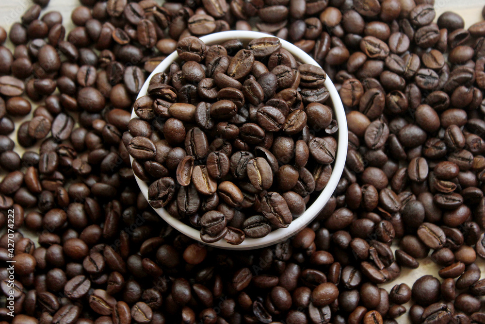 Closeup of roasted coffee beans on top of the table Closeup of roasted coffee beans on top of the table