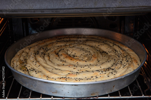 Bosnian borek. Homemade rolled borek, spinach, potato and feta cheese, turkish cuisine. Turkish Culture Ramadan and Eid-Adha holiday catering preparation. photo