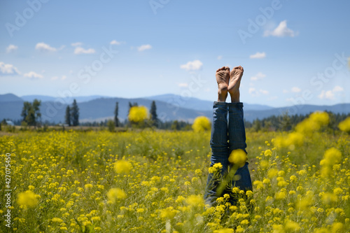 Feet and Handstand among yellow flowers © Chris
