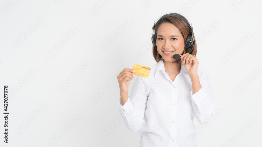 Woman call center with headset holding and credit card. Woman call center with headset holding and credit card.