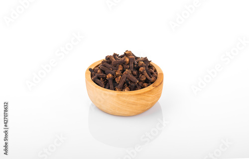 Clove, clove seed. Clove seed in wooden bowl, on white background